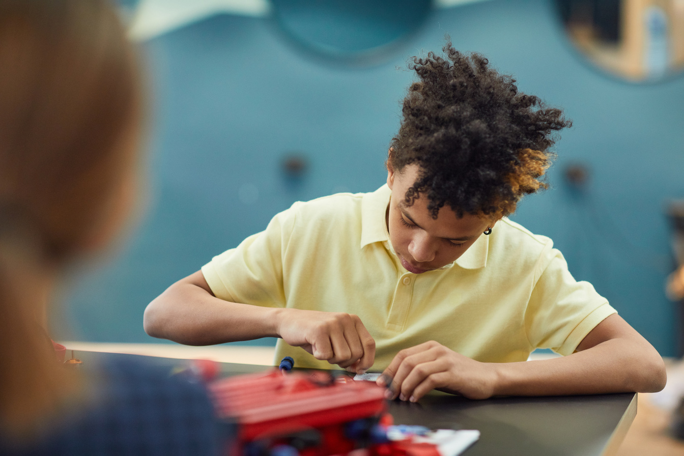 Ethnic kid working on project